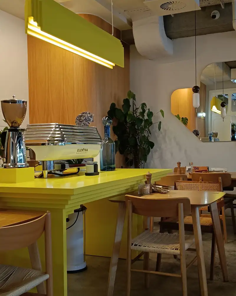 The yellow bar with a lamp and wooden stools