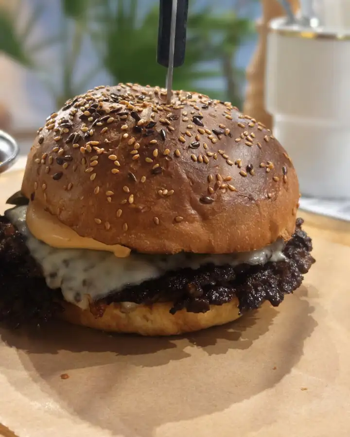 A burger on a seeded bun