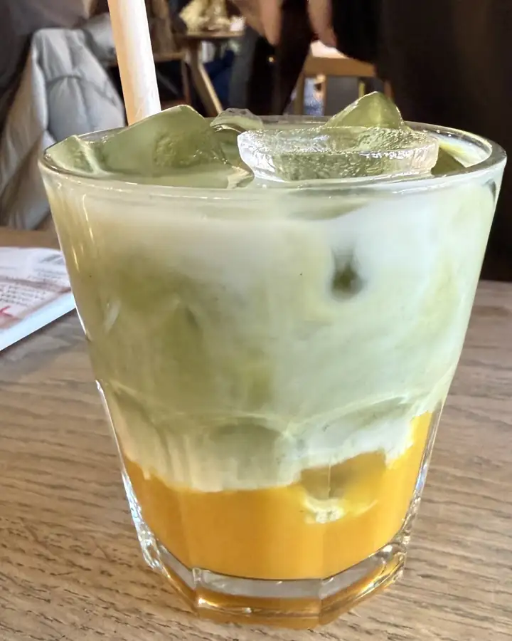 Iced mango matcha latte in a tall glass