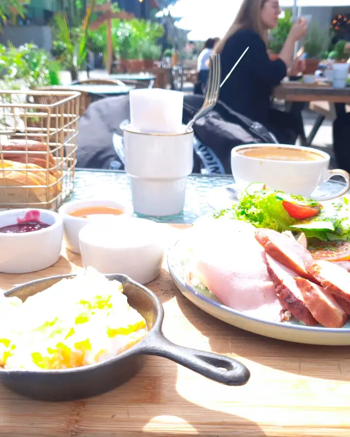 Kashubian breakfast with eggs in a skillet, cold cuts and salad